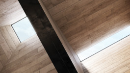two glass skylights; one square, one rectangular, casting light and shadow over sculptural high ceilings clad in rough sawn oak panels 