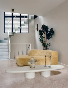retro yellow velvet designer sofa by Ennio Chiggio in a stylish, off-white living room 