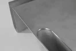 Aluminium table with sculptural feet and polished edges 